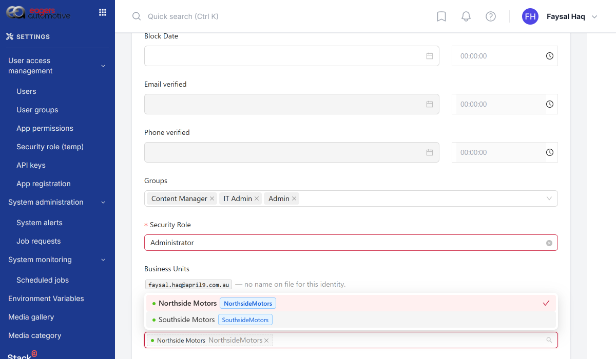 Instance settings user edit screen with the Business Units field expanded, showing Northside Motors selected and Southside Motors unselected for a user